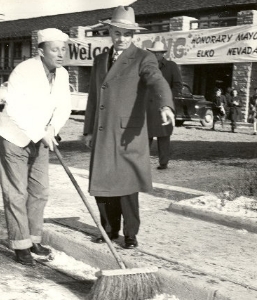 Honorary Mayor Bing Crosby sweeping Elko street supervised by Mayor Dave Dotta, 1948